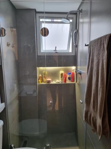 a bathroom with a shower with a glass door at Best Residence in Rio de Janeiro