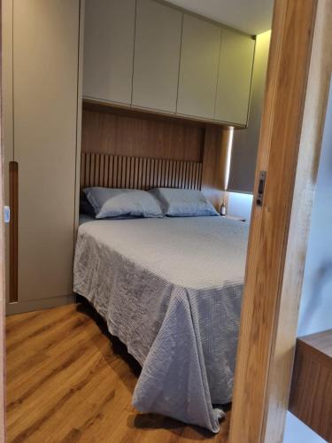 a bedroom with a bed with a wooden floor at Best Residence in Rio de Janeiro