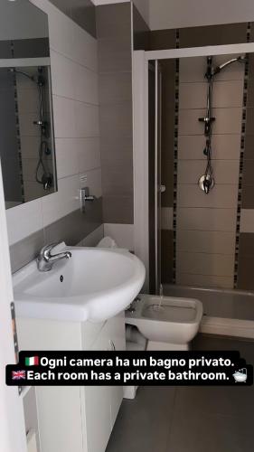 a bathroom with a sink and a toilet at Aurea Suites in Palermo