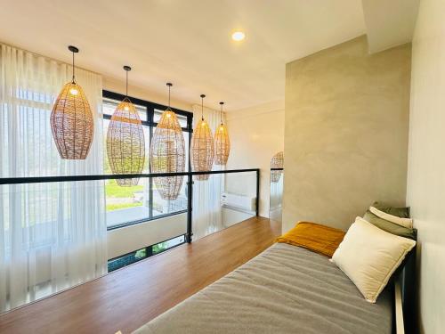 a bedroom with a bed and pendant lights at Saffron Villa in Pampang