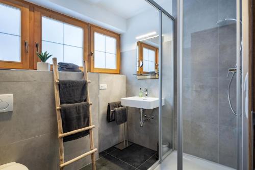 a bathroom with a shower and a sink at Chalet Veronika in Fieberbrunn