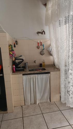 a kitchen with a sink and a counter top at Casa - BC in Balneário Camboriú