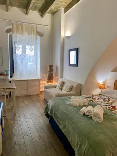 a large bedroom with a bed and a couch at B&B le TRE CHIOCCIOLE in SantʼAntìoco