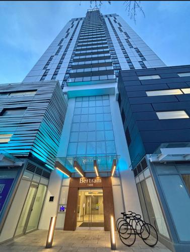 a tall building with a bike parked in front of it at Stunning Lake Views - downtown 2 Bedroom apartment - rooftop lounge in Kelowna