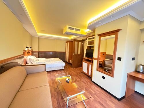 a hotel room with a bed and a couch at California Hotel in Sofia