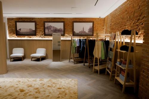 a clothing store with chairs and racks of clothes at Pana Unique Semey in Semey