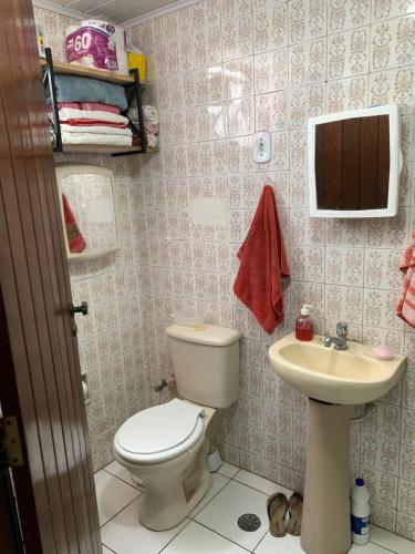 a bathroom with a toilet and a sink at Apto jaraguá lindo in Maceió