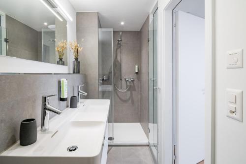 a bathroom with a shower and a sink at Apartments Quellenhöfli in Vitznau