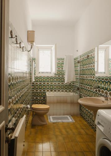 a bathroom with a toilet and a sink at Ampelaki Blue in Paleokastritsa