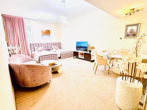 a living room with a couch and a table at Sea View Holiday Home with Parking in Ajman 