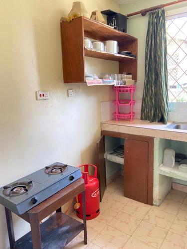 a kitchen with a blue stove and a counter at Karmo Suites in Mombasa