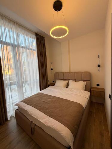 a bedroom with a large bed with a large window at 10 minutes from skiing in Bakuriani