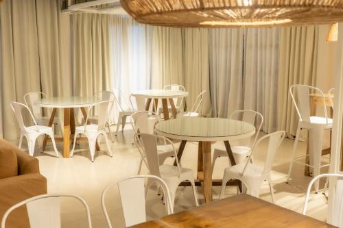 een kamer met witte tafels en witte stoelen bij Portezuelo Hotel in Salta