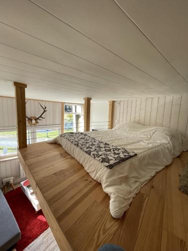 a large bed in a room with a canopy at Studio duplex hyper centre 4 personnes in Le Lioran