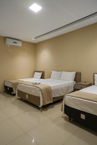 a room with two beds in a room at Pousada BarbacoaR in Parnaíba