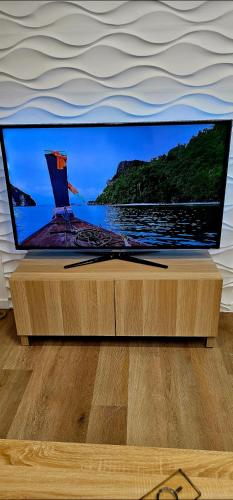 a flat screen tv sitting on top of a wooden table at Cabedelo Studio Residence in Viana do Castelo