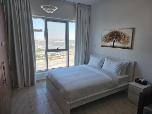 a bedroom with a bed and a large window at Skycourts - Well furnished Studio apartment in Dubai
