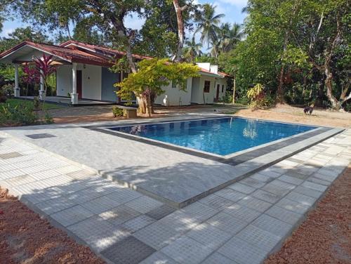 a swimming pool in the yard of a house at Tranquillity Villa in Colombo
