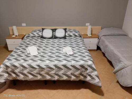 a bed with a pair of glasses on top of it at La Villa Di Zio Pino in Camerino