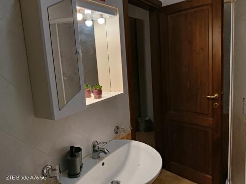 a bathroom with a sink and a medicine cabinet at La Villa Di Zio Pino in Camerino
