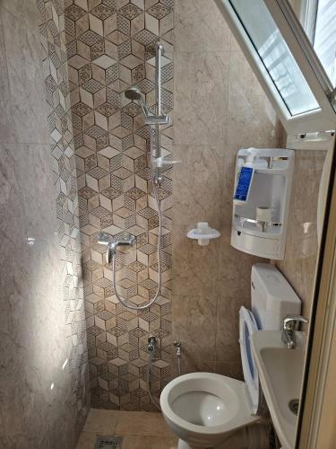 a bathroom with a shower and a toilet at The Graziano 2 house in Sousse