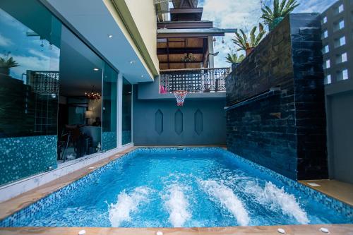 ein Schwimmbecken in einem Haus mit Basketballkorb in der Unterkunft De Thaphae Chiangmai in Chiang Mai