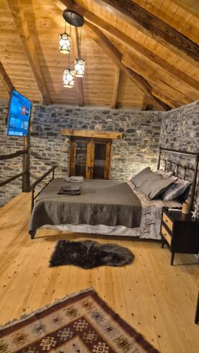 a bedroom with a bed and a tv in a room at Black Rock Agria in Agria