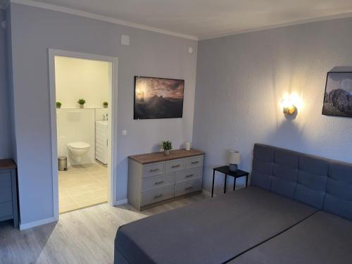 a large room with a bed and a bathroom at 4-Bett-Appartement am Golfplatz in Grassau