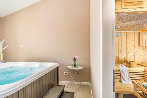 a bathroom with a tub and a sink at Villa Sterpazzi near Poreč with heated private pool, sea view, jacuzzi and sauna in Višnjan