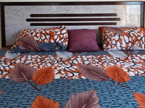 a bed with colorful sheets and pillows on it at The Sunrise Retreat in Solan