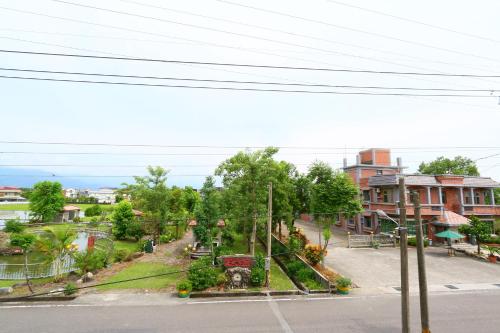 an empty street in a town with trees and buildings at Jheng Tong House in Dayin
