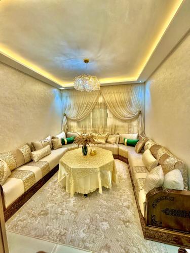 a living room with a couch and a table at Afalux Brand chic in Agadir