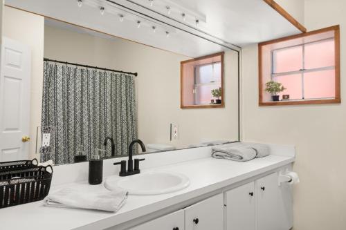 a bathroom with a sink and a large mirror at Circle Overlook-Downtown Apartment Stay in Sebring