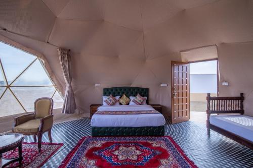 a bedroom in a tent with a bed and a table at Crystal Resort in Sām