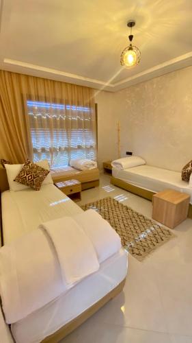 a bedroom with two beds and a window at Imsouane Sea surf Camp in Imsouane