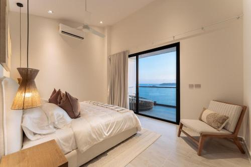 a bedroom with a bed and a view of the ocean at 3082 - Paradise Cove 3A Manzanillo in Tangolunda