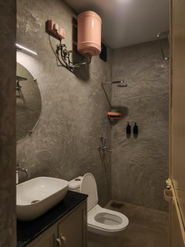 a bathroom with a sink and a toilet and a mirror at Florin Studio in Vagator