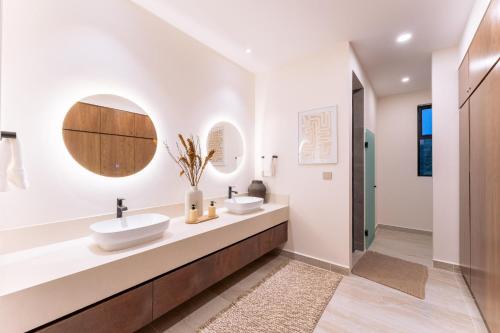 a bathroom with two sinks and a walk in shower at 3082 - Paradise Cove 3A Manzanillo in Tangolunda