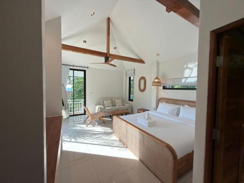a bedroom with a bed and a living room at Blue Sky Seaview in Haad Yao