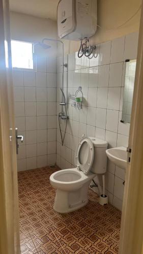 a bathroom with a toilet and a sink at Puncak azoul villa in Cinengangirang