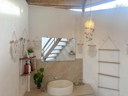 a bathroom with a sink and a mirror at Hideout Sunset in Nusa Penida
