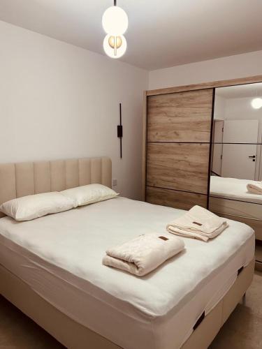 a bedroom with a bed with towels on it at Villa Elmiso Sarajevo in Sarajevo