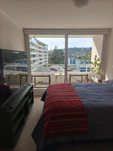 En eller flere senge i et værelse på Departamento Reñaca Bajo