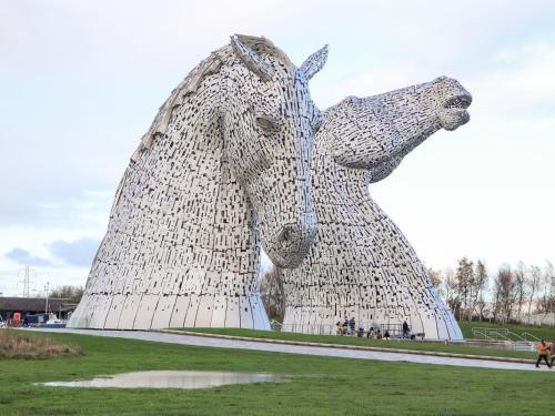 a statue of a horse standing in a field at Beechtree Timber Lodge 69B in Denny