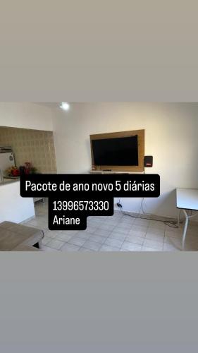 a tv on a wall in a room at Casa Vera Cruz in Mongaguá