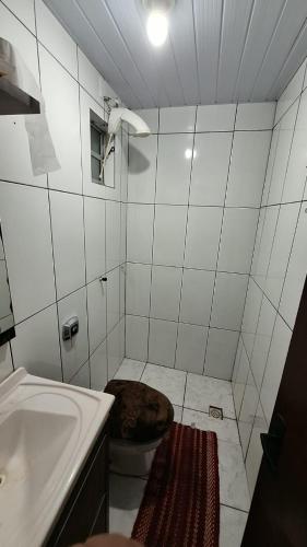 un bagno con un cane sdraiato sul water di Casa do Rabelo a Balneário Gaivotas