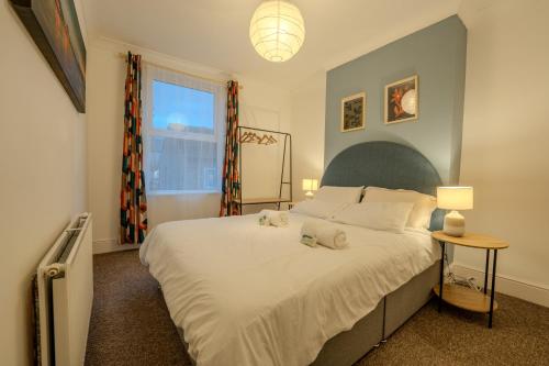 a bedroom with a bed with two stuffed animals on it at The Salty Seagull in Scarborough