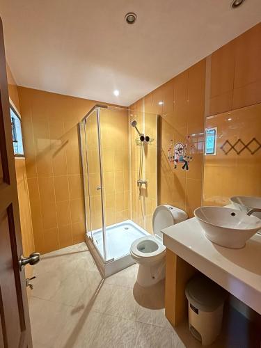 a bathroom with a shower and a toilet and a sink at NS Private Pool villa in Ban Na Kok