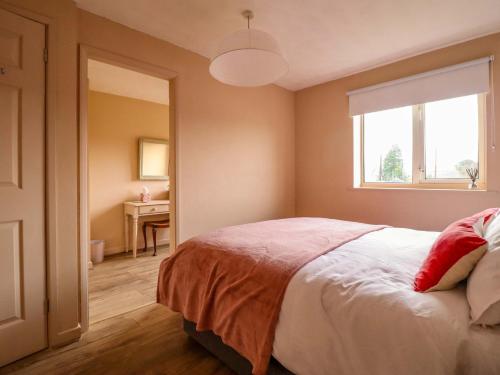 a bedroom with a bed and a window and a desk at 2 Horseshoe Road in Montgomery