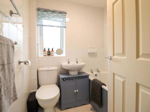 a bathroom with a toilet and a sink at 2 Horseshoe Road in Montgomery